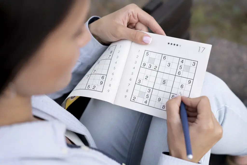 person playing sudoku game alone